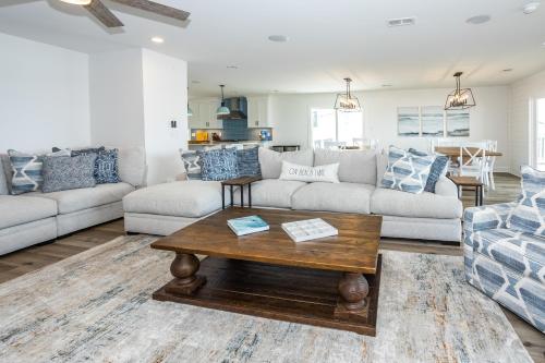 a living room with a couch and a coffee table at Beachfront Bliss in North Topsail Beach