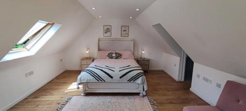 a bedroom with a bed in a attic at The Workshop in Elham
