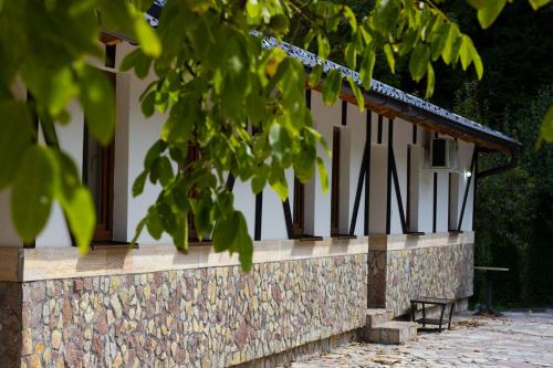 a building with a bench in front of it at Apartment with river Una view / Ilma 2 in Bihać