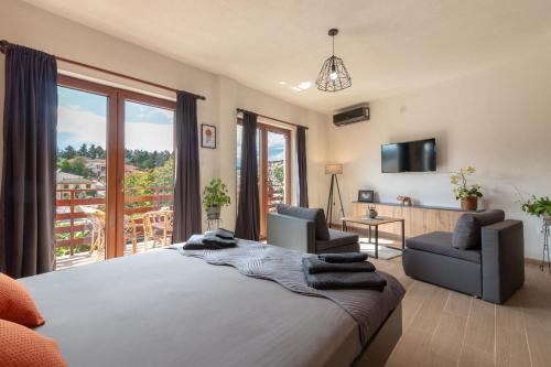 a bedroom with a large bed and a balcony at City Gate Apartment in Ohrid