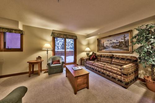 a living room with a couch and a chair at Timberline Village #38 By Bear Country in Sun Peaks