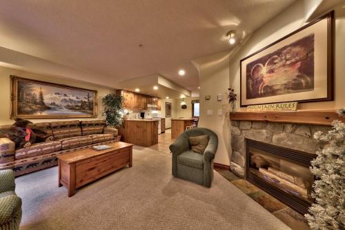 a living room with a couch and a fireplace at Timberline Village #38 By Bear Country in Sun Peaks