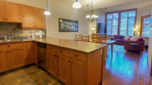 a kitchen with a large island in the middle of a room at Settlers Crossing #29 By Bear Country in Sun Peaks