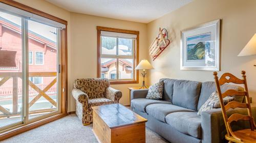 a living room with a couch and a chair at Fireside Lodge #315 By Bear Country in Sun Peaks