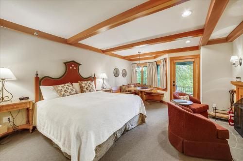 a large bedroom with a large bed and a chair at Trapp Villa 29 in Stowe