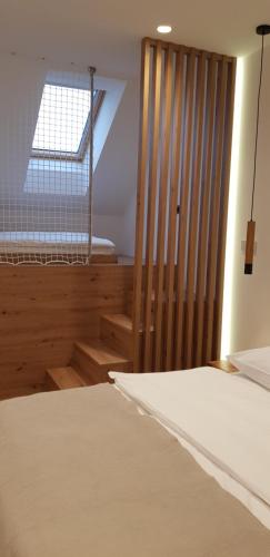 a bedroom with a bed and a window and a crib at AppPrusnik in Ljubljana