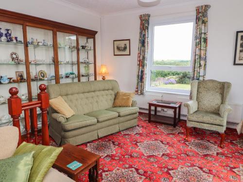 a living room with a couch and a chair at West Croft in Mawbray