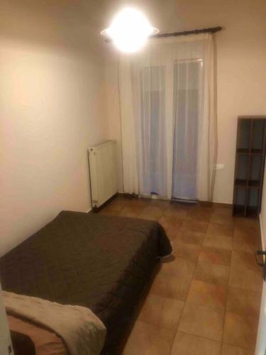 a bedroom with a bed and a light on the ceiling at Apartment MCS in Igoumenitsa