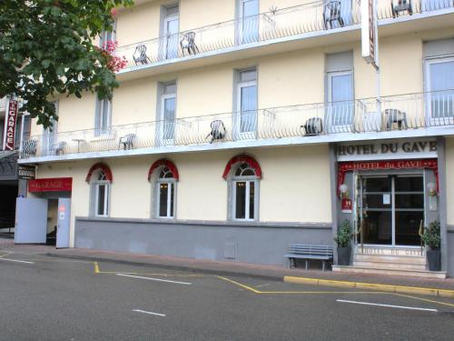 a building on the corner of a street at Hotel Du Gave in Lourdes