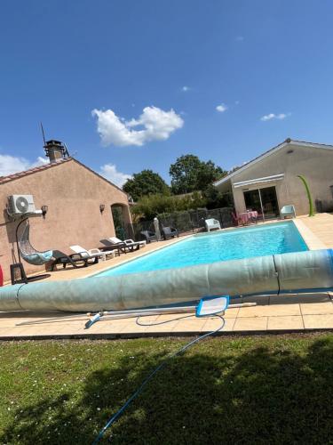 a swimming pool with a large inflatable at Maison de vacances in Coufouleux