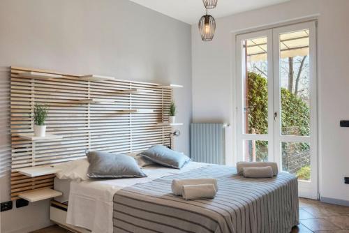 a bedroom with a large bed with two pillows on it at Relax by the pool - Garden - Garage in Polpenazze del Garda