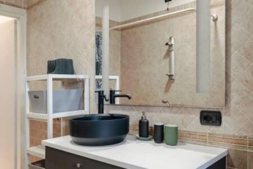 a bathroom with a sink and a shower with a mirror at Relax by the pool - Garden - Garage in Polpenazze del Garda