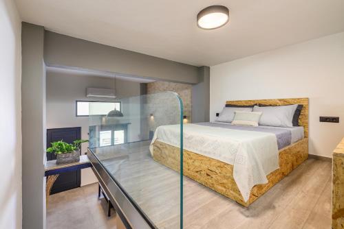 a glass room with a bed and a glass table at Loft 1 in Kos Town