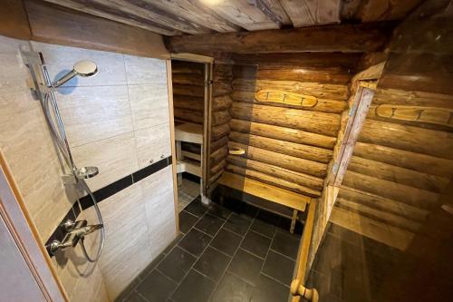 a small bathroom with a shower in a wooden house at Kütioru saunamajad in Koloreino