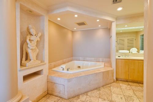 a bathroom with a tub with a statue in it at La Jolla Condo Rental Ocean View, Jetted Tub in San Diego