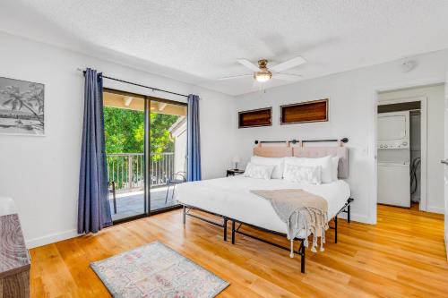 a bedroom with a bed and a balcony at Kahala 924 in Koloa