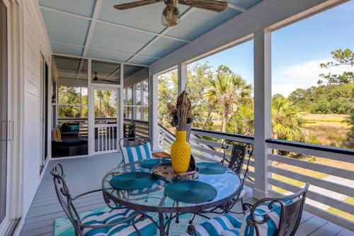 a screened porch with a table and chairs on it at Nature's Touch in Edisto Island