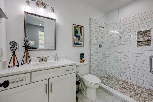 a white bathroom with a toilet and a shower at Nature's Touch in Edisto Island