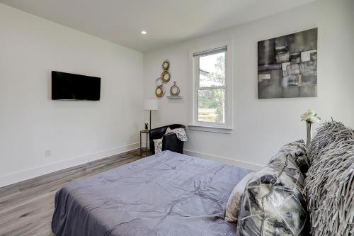 a white room with a bed and a tv at Nature's Touch in Edisto Island