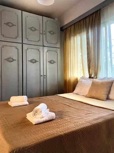 a bedroom with two towels on a bed at Diamond's House in Kallithea Halkidikis