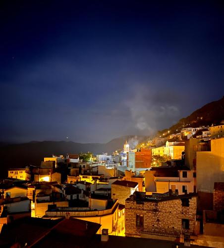 a view of a city at night with buildings at Goloritzè Room and Breakfast in Baunei