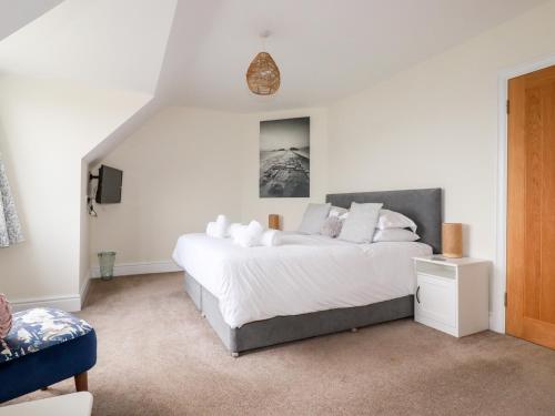 a bedroom with a large white bed in a room at Number 37 in Bude
