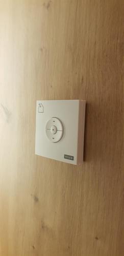a white electrical outlet on a wall at AppPrusnik in Ljubljana