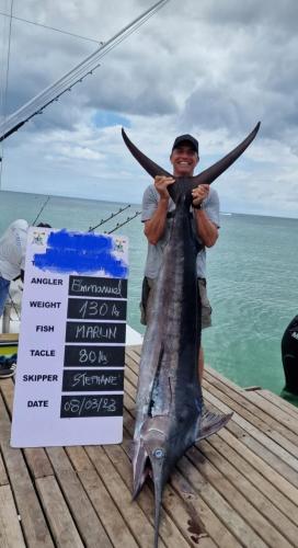 a man holding a fish on a dock at Casa JEM in Albion