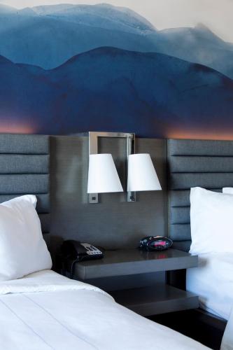 a bedroom with a bed and two lamps on a wall at Franklin Marriott Cool Springs in Franklin