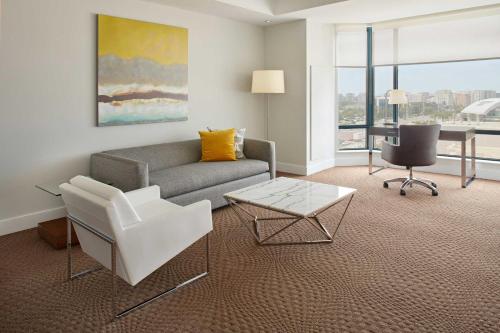 a living room with a couch and a table at Sheraton Parkway Toronto North Hotel & Suites in Richmond Hill