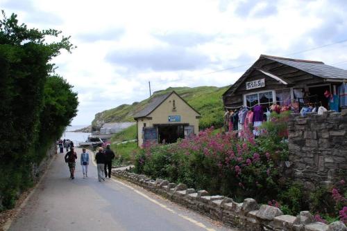 a group of people walking down a road next to a building at 2-6 guests Holiday Home in Durdle Door in Wareham