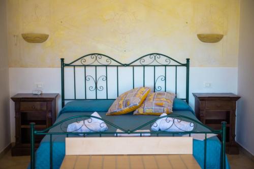 a bedroom with a bed with blue sheets and pillows at Villa Conca Marco in Vanze