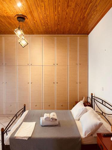 a bedroom with a bed with two towels on it at GIALOS APARTMENT in Elafonisos