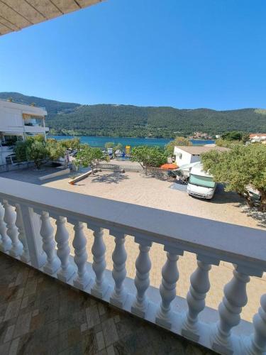 a white balcony with a view of a beach at Sunce Mobile Homes & apartments in Grebaštica