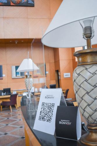 a table with a lamp and a sign on it at Sheraton Pilar Hotel & Convention Center in Pilar