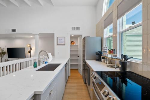 a kitchen with white countertops and a large window at Chic Uptown Phoenix Home - Pool Table & Perfect Location in Phoenix