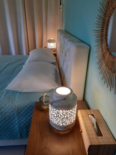 a bedroom with a bed with a wooden table next to it at Olive House in Kalamaki