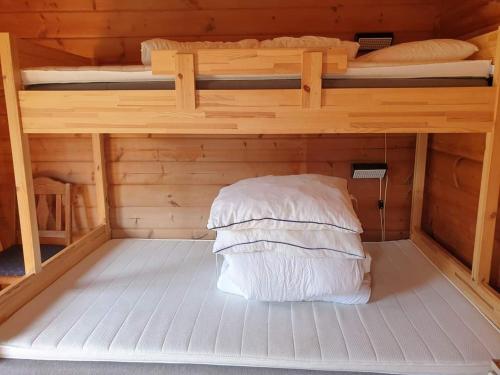 a bedroom with two bunk beds in a cabin at Kirketeigen Camping in Kvam