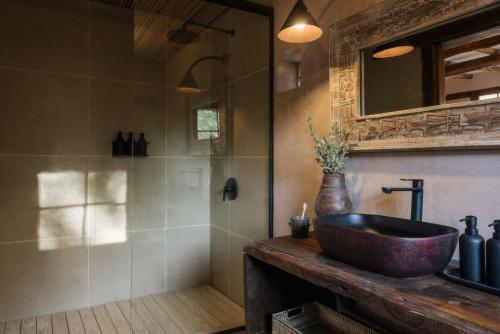 a bathroom with a sink and a mirror at Our Habitas Atacama in San Pedro de Atacama