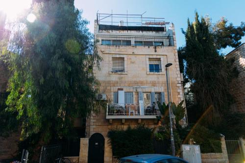 a brick building with a balcony on top of it at Haran in Jerusalem