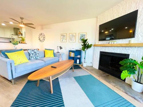 a living room with a table and a couch and a fireplace at IB Seaside Paradise w/ Ocean Views! in Imperial Beach