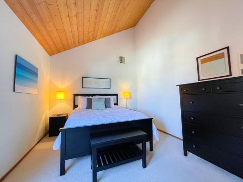 a bedroom with a bed with a black dresser and a piano at IB Seaside Paradise w/ Ocean Views! in Imperial Beach
