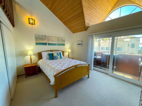 a bedroom with a bed and a large window at IB Seaside Paradise w/ Ocean Views! in Imperial Beach
