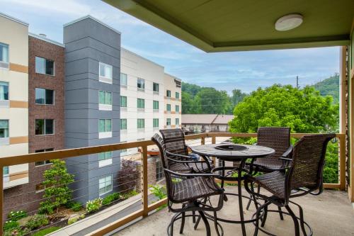 a patio with a table and chairs on a balcony at Convenient Gatlinburg Condo in Gatlinburg