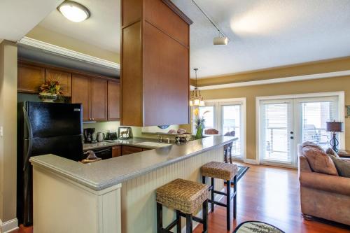 a kitchen with a bar with stools in a room at Convenient Gatlinburg Condo in Gatlinburg