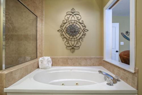a bathroom with a large tub with a mirror at Convenient Gatlinburg Condo in Gatlinburg