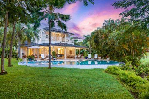 a house with a swimming pool in a yard at Royal Westmoreland - Villa Rosa by Island Villas in Saint James