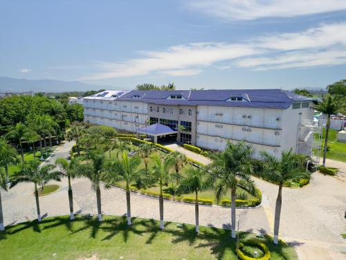 an aerial view of a hotel with palm trees at Colonial Plaza Hotel Pindamonhangaba in Pindamonhangaba