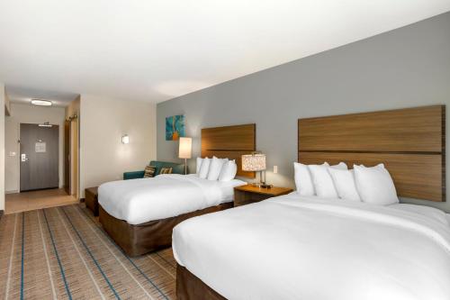 a hotel room with two beds and a couch at MainStay Suites North - Central York in York