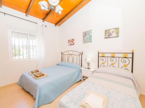 a bedroom with two beds and a window at Cubo's Finca Fernando in Coín